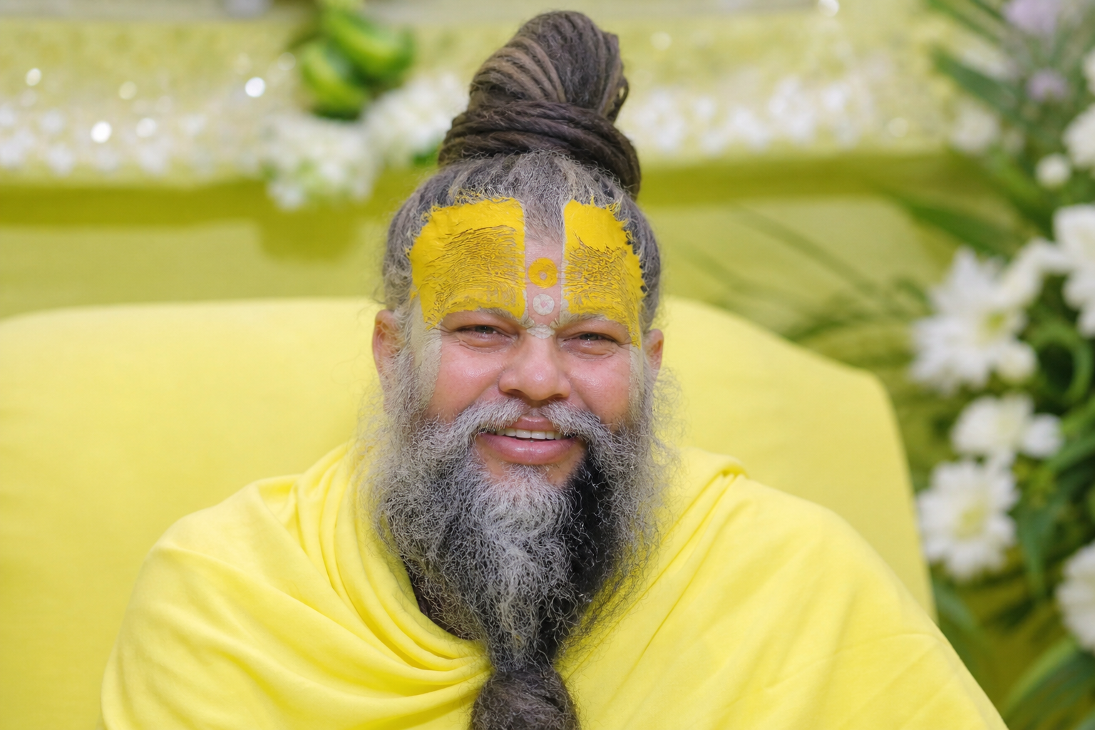 Premanand Ji Maharaj smiling face with calm expression and spiritual glow in simple saffron attire